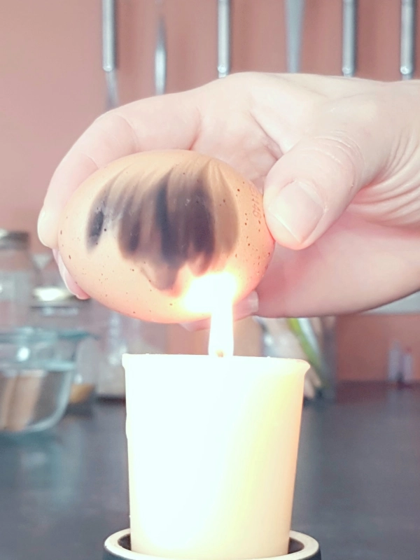 egg on a flame with soot